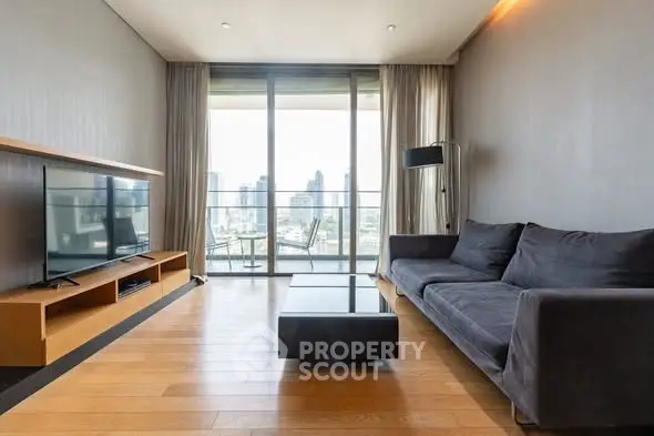 Modern living room with sleek furniture and city view balcony, perfect for urban living.