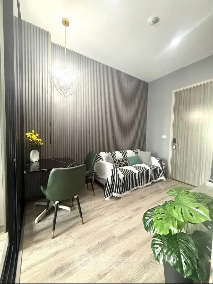Modern living room with stylish decor and cozy seating area, featuring elegant lighting and contemporary design.