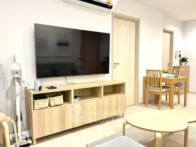 Modern living room with sleek wooden furniture and wall-mounted TV, perfect for cozy family gatherings.
