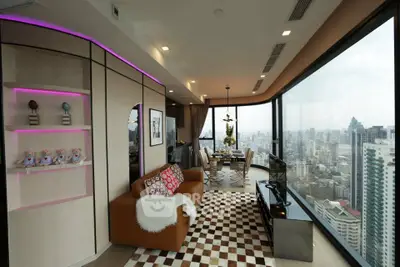 Luxurious corner unit living room with panoramic city views and modern decor.