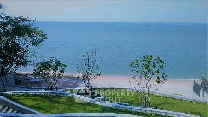 Stunning beachfront view with lush greenery and serene ocean backdrop