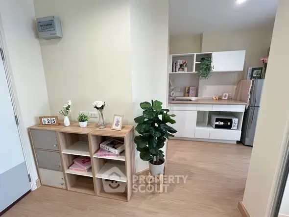 Modern apartment interior with stylish kitchen and decorative plants.