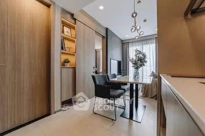 Modern dining area with sleek furniture and natural light in a stylish apartment.