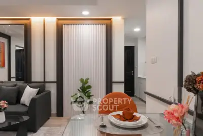 Modern living room with stylish decor and dining area in a contemporary apartment.
