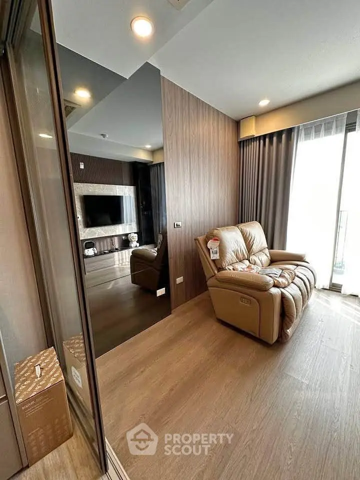 Modern living room with cozy leather sofa and sleek wooden flooring
