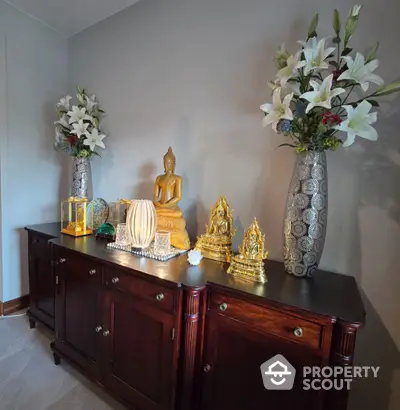 Elegant interior decor with wooden cabinet and decorative vases in a serene living space.