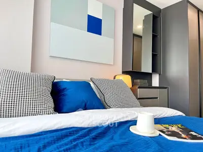 Modern bedroom with stylish decor and vibrant blue accents, perfect for relaxation and comfort.