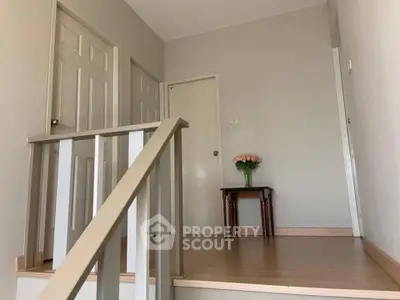 Charming hallway with wooden flooring and elegant decor, perfect for a welcoming home atmosphere.