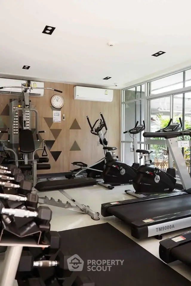 Modern gym with state-of-the-art equipment in a luxury residential building.