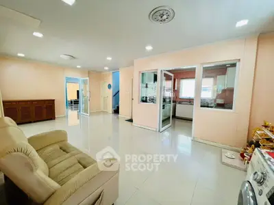 Spacious living room with modern open layout and sleek tiled flooring
