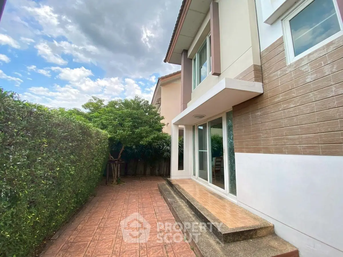 Charming exterior view of modern house with spacious patio and lush greenery.