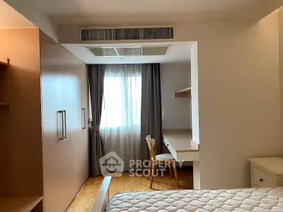 Cozy bedroom with study nook and ample natural light, featuring modern furniture and elegant design.