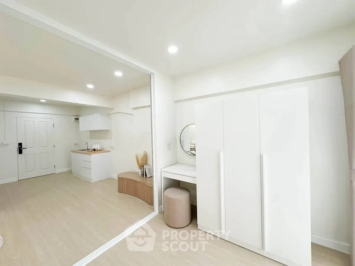 Modern minimalist apartment interior with open layout and sleek white furniture