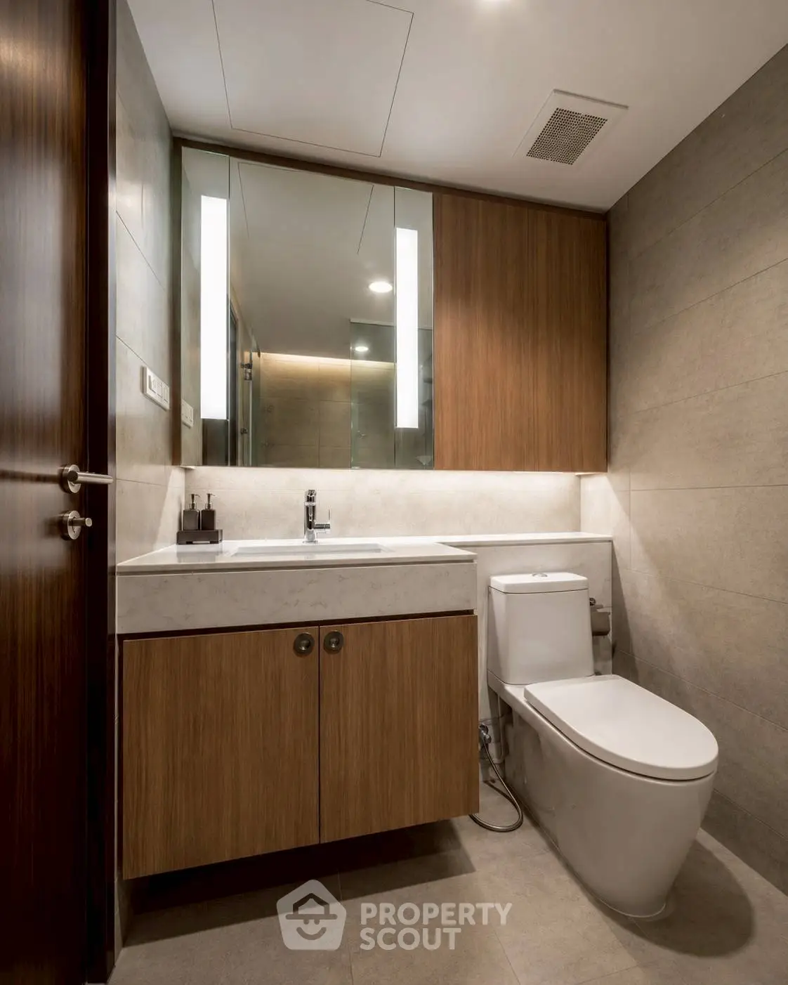 Modern bathroom with sleek fixtures and wooden cabinetry in a contemporary apartment.