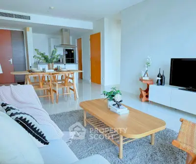 Modern living room with stylish furniture and open kitchen layout