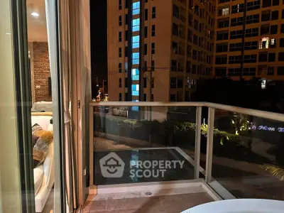 Chic urban balcony with city view, perfect for relaxing evenings.