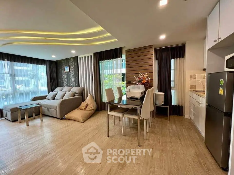 Spacious modern living room with stylish decor and open kitchen layout in a luxurious apartment.