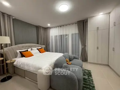 Luxurious bedroom with modern decor and cozy seating area