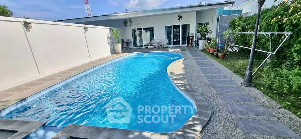 Stunning private pool with modern patio in luxurious backyard setting