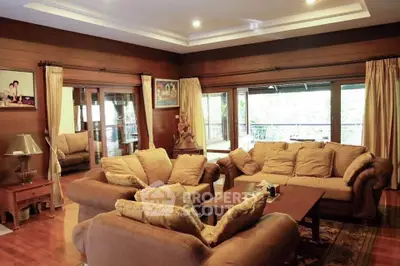 Luxurious living room with plush sofas and wooden decor, perfect for relaxation and entertaining.