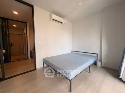 Modern minimalist bedroom with sleek design and air conditioning