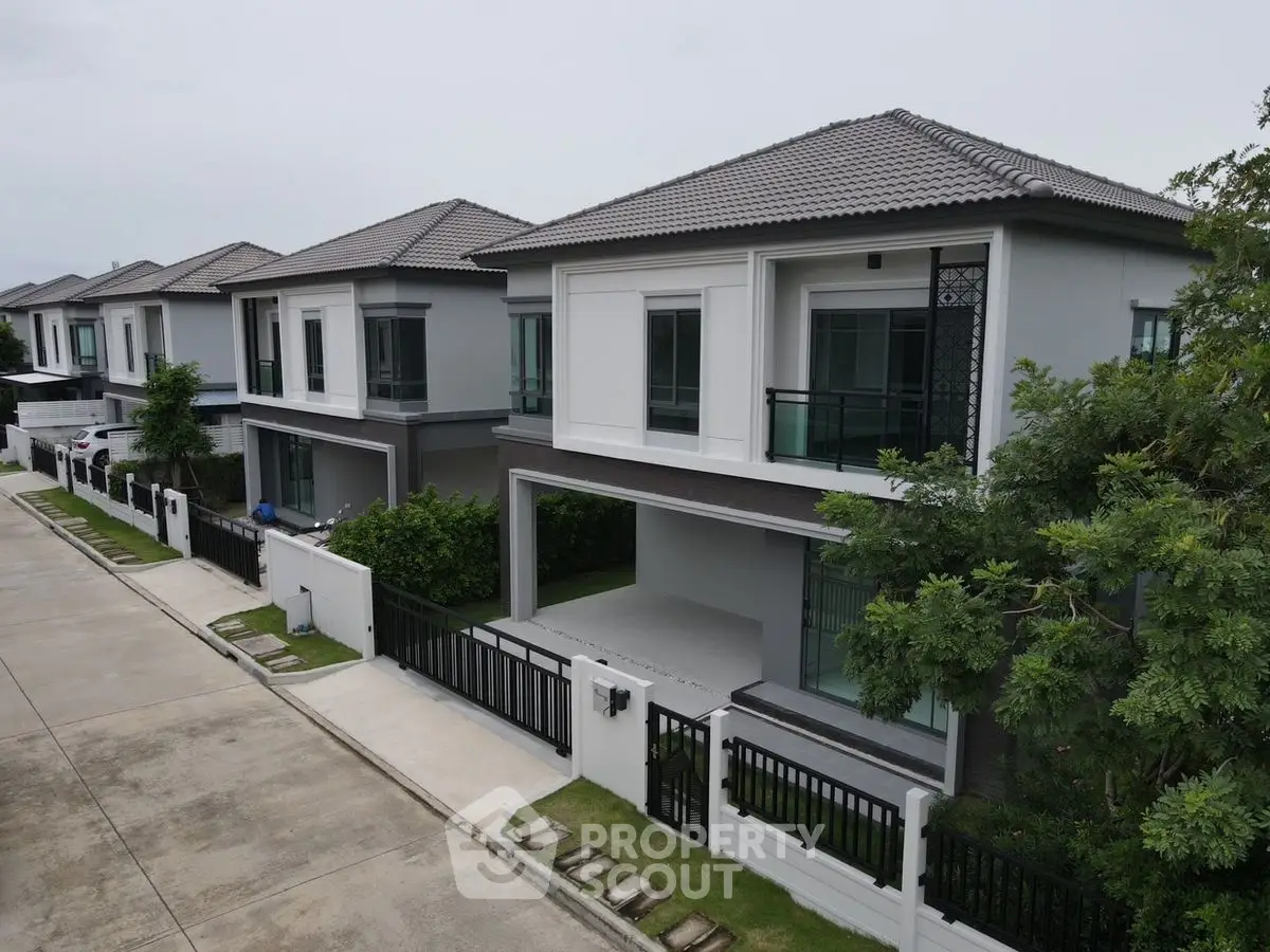 Modern suburban homes with sleek design and spacious driveways in a serene neighborhood.