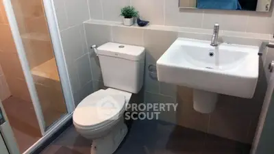 Modern bathroom with sleek fixtures and glass shower enclosure