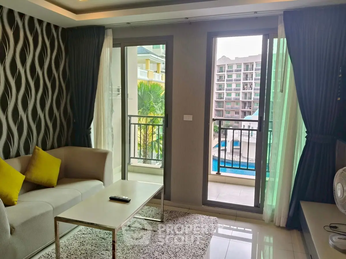 Modern living room with pool view and stylish decor in a high-rise apartment.