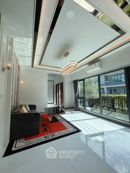 Luxurious living room with modern design and large windows offering garden view