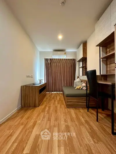 Modern living room with wooden flooring, stylish furniture, and cozy ambiance.