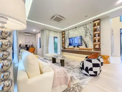 Luxurious modern living room with elegant decor and stylish furniture, featuring a marble accent wall and large windows.