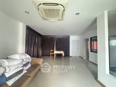 Spacious living room with modern air conditioning and ample natural light, perfect for comfortable living.