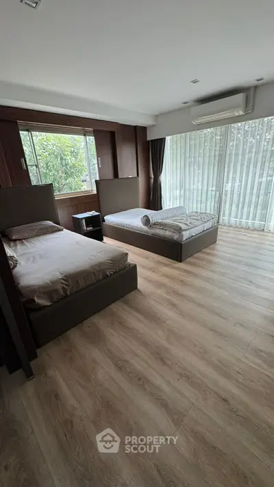 Spacious bedroom with large windows and modern decor