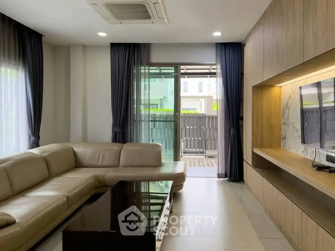 Modern living room with sleek design and large windows for natural light.