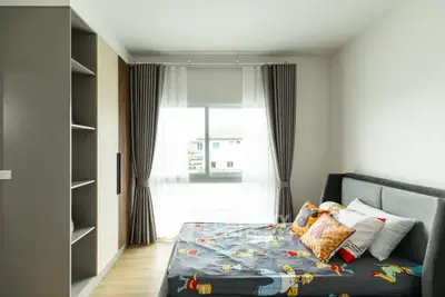 Bright and cozy bedroom with modern decor and ample natural light