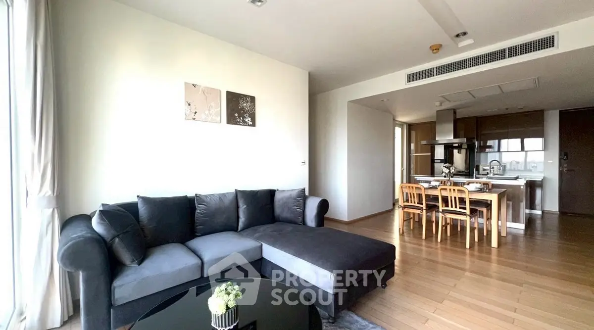 Spacious modern living room with elegant decor and open kitchen layout