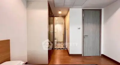 Modern bedroom with wooden flooring and sleek closet design