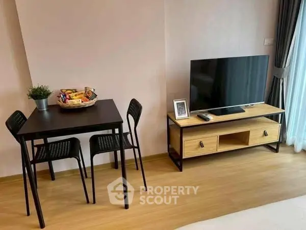 Modern living room with sleek TV stand and cozy dining area