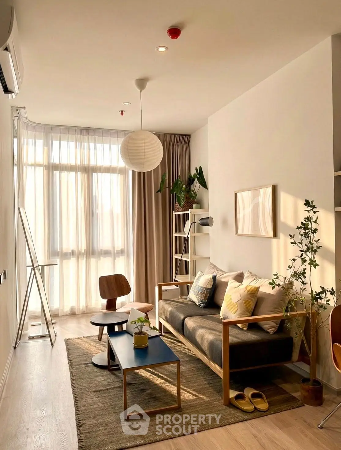 Charming sunlit living room with modern decor and cozy seating area.