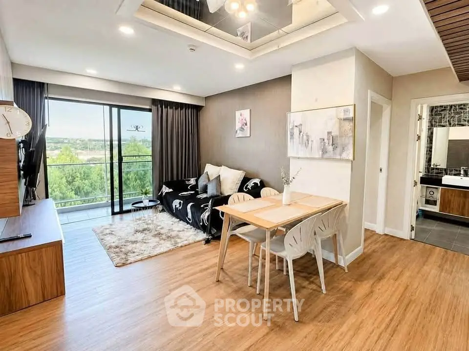 Modern living room with stylish decor and scenic balcony view