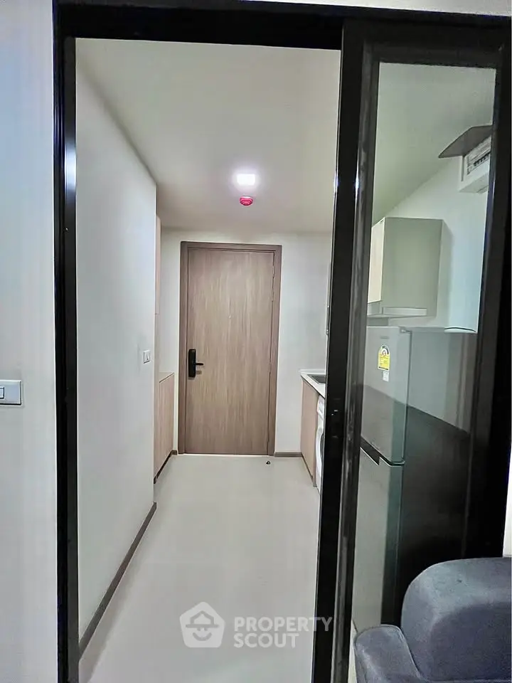 Modern apartment entrance with sleek kitchen and stylish appliances