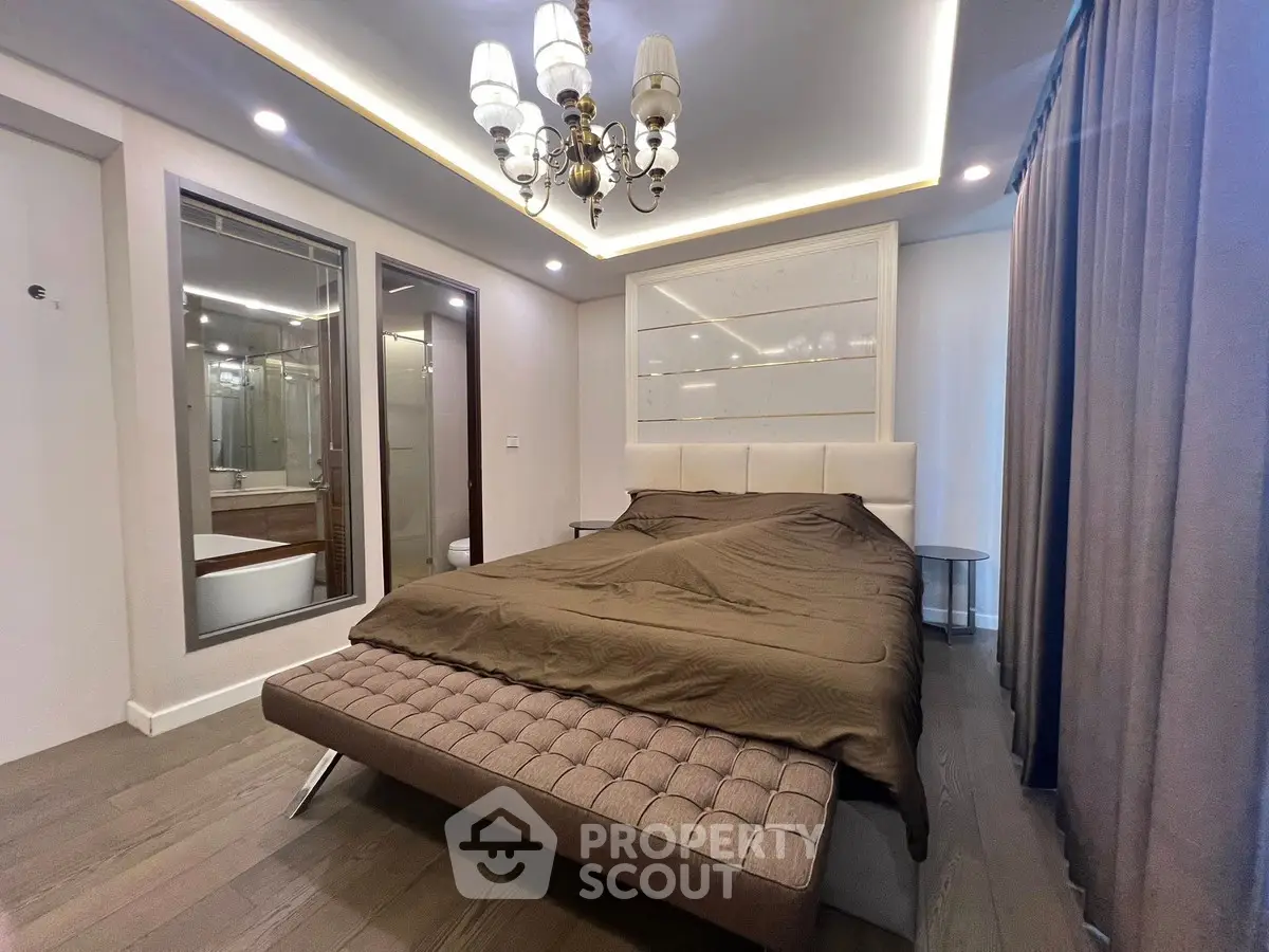 Luxurious bedroom with elegant chandelier and modern decor