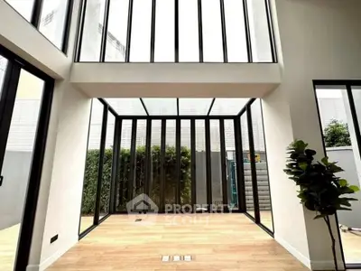 Stunning modern living space with floor-to-ceiling windows and elegant wooden flooring.