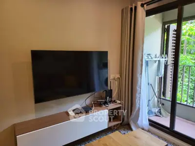 Modern living room with wall-mounted TV and balcony view