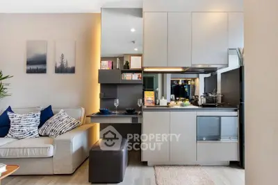 Modern open-plan living room and kitchen with sleek design and cozy ambiance.