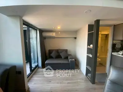 Modern living room with cozy sofa and balcony access in stylish apartment