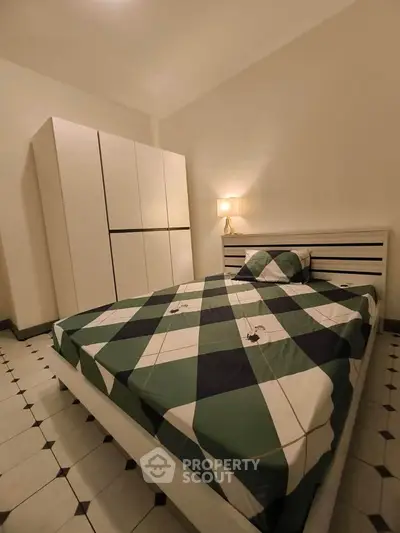 Cozy bedroom with modern wardrobe and stylish bed in elegant apartment.