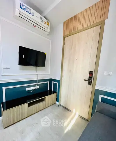 Modern living room with wall-mounted TV and stylish air conditioning unit