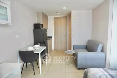 Modern studio apartment with compact kitchen and cozy living area