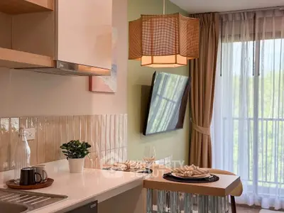 Modern kitchen with open layout and stylish decor, featuring a breakfast bar and large window view.